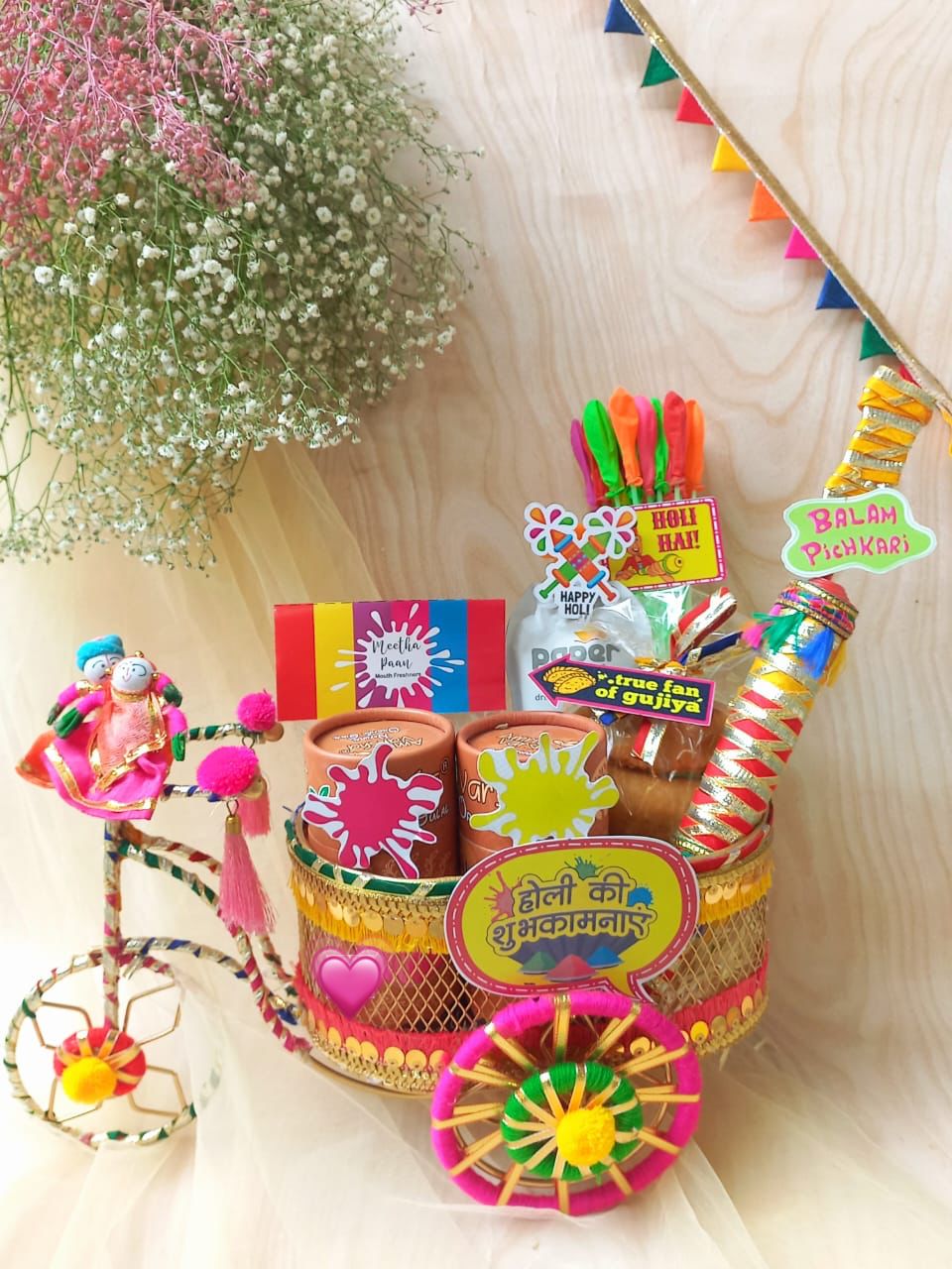 Colorful Diwali gift basket with traditional items on a light background