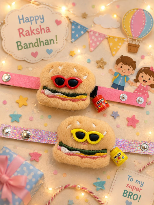 Two plush toy burger puffs wearing colorful sunglasses are displayed on pink glittery bands with silver snaps, decorated with festive Raksha Bandhan themed props, star stickers, fairy lights, and gift boxes.