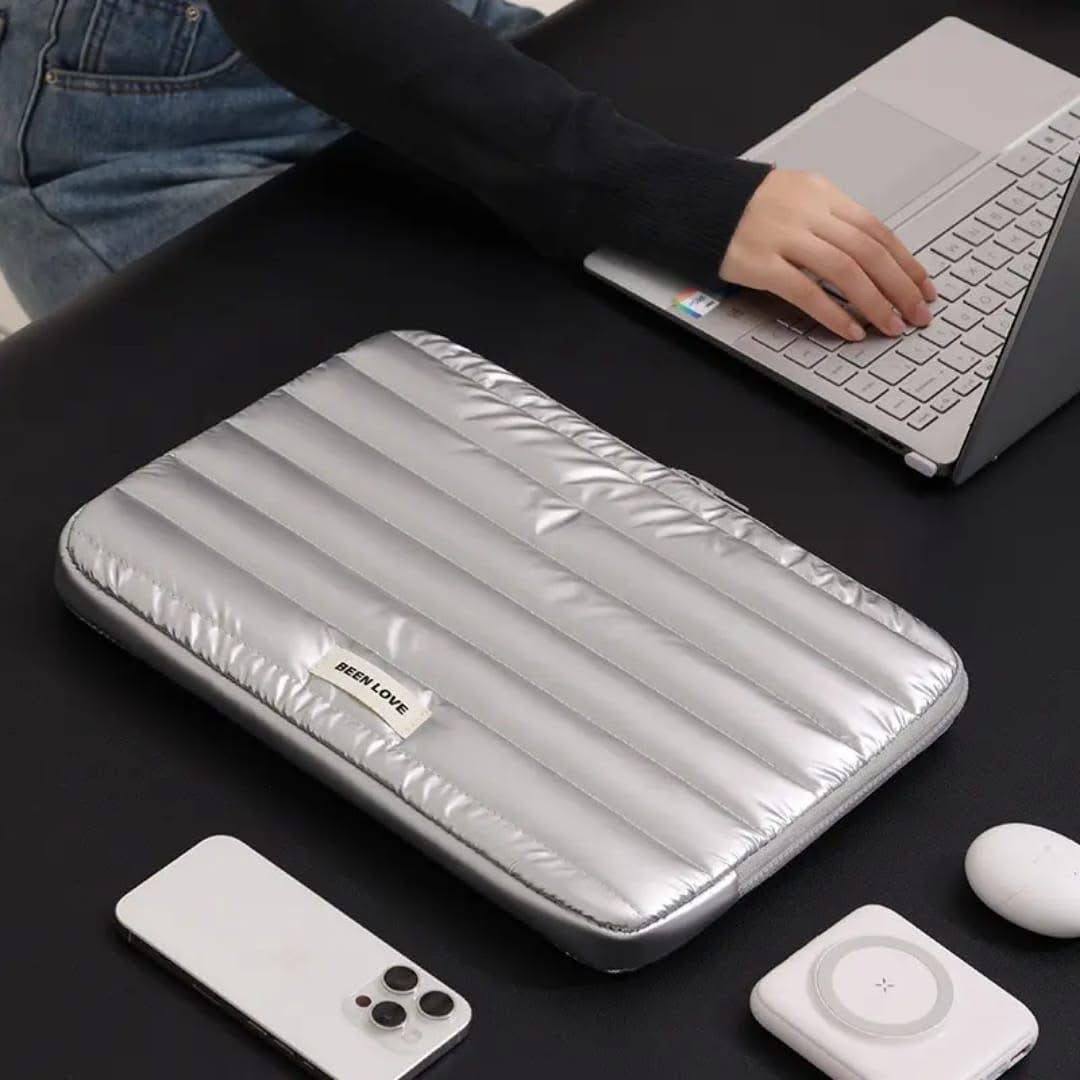 Silver laptop case on a desk with a laptop, phone, and mouse nearby