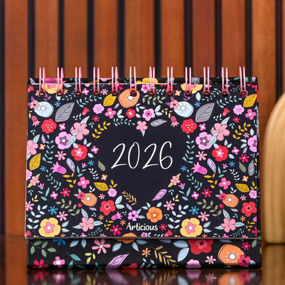 Floral-patterned 2026 calendar with 'Articious' branding on a wooden surface.